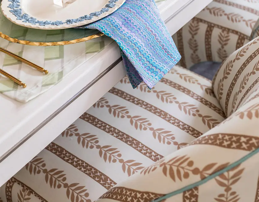 Upholstered dining chairs at set table.